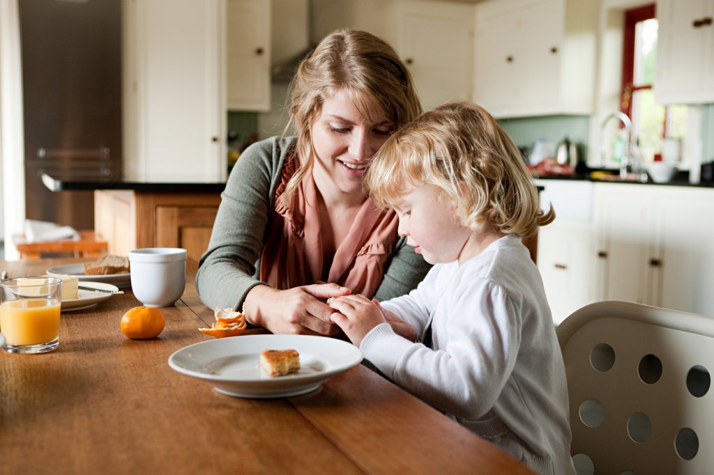 Mother and daughter having breakfast.